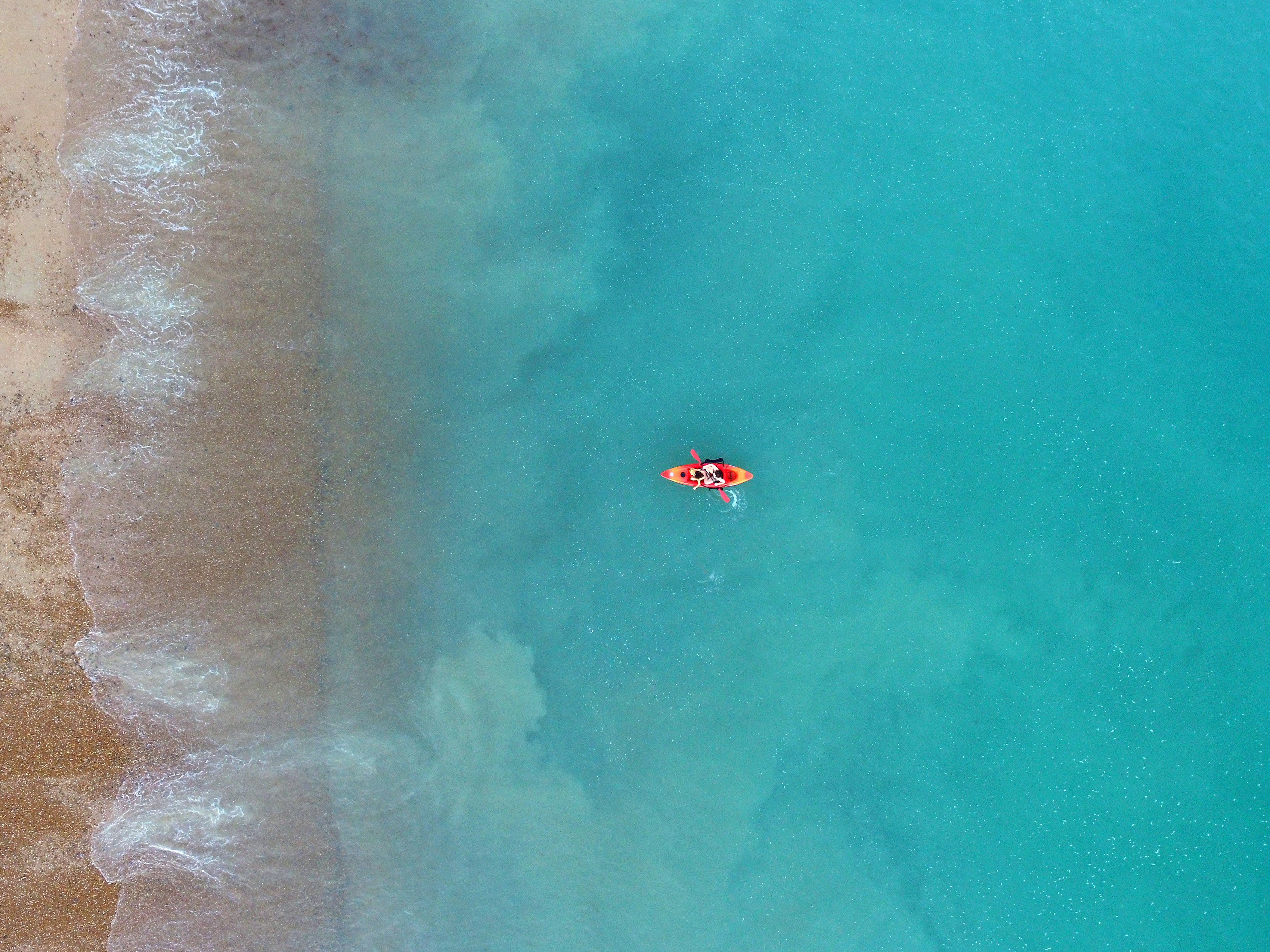 person kayaking on body of water